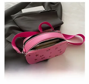 Internal view of pink cherry crossbody bag showing storage for phone and long wallet