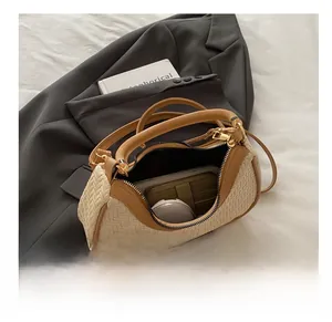 Detailed interior of woven crossbody bag showing large capacity for wallet and cosmetics