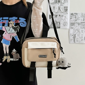 Japanese style khaki canvas messenger bag with wide shoulder strap and plush octopus charm