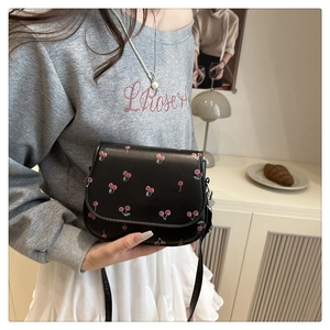 Close-up of black cherry print crossbody bag showing vegan leather texture and vintage style