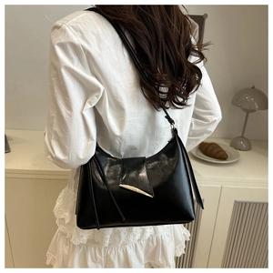 Minimalist black faux leather hobo shoulder bag with a silver crescent metal buckle