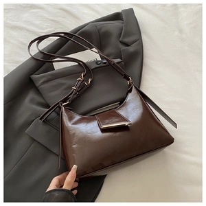 Detailed macro view of dark coffee oily leather bag with a metallic buckle and strap
