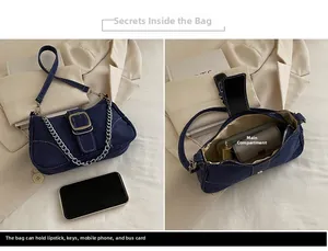 Detailed interior capacity view of denim shoulder bag with metal chain and buckle