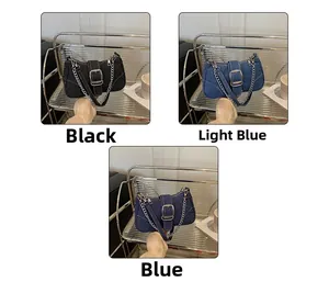 Detailed view of vintage denim shoulder bags with metal buckles in three colors