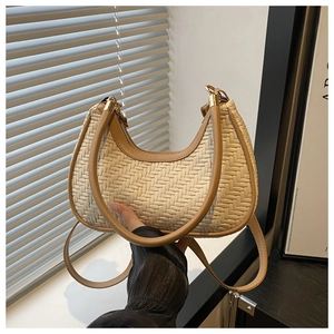 Detail of woven crescent hobo bag with contrast faux leather trim and dual straps