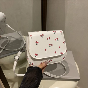 White cherry print saddle bag with chain strap and adjustable leather shoulder strap