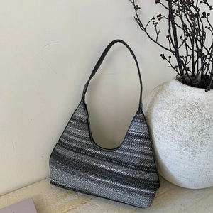 Detail view of woven fabric texture and black and white stripes on this hobo bag
