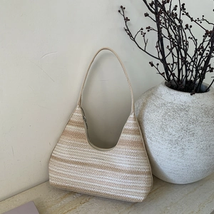 Macro detail of striped woven hobo bag with earth-toned rustic home decor background
