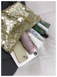 Spacious gold sequin tote bag interior showing large capacity for essentials and cosmetics