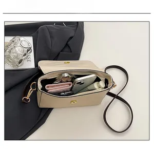 Interior view showing the large capacity of the beige pebble leather crossbody bag