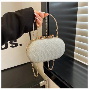 Silver sequin evening bag with gold ring handle and butterfly clasp detail