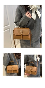 Detail of caramel lychee grain leather bag showing gold buckle and top handle