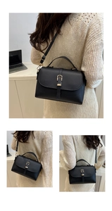 Detail of black lychee grain leather handbag featuring gold buckle and detachable strap