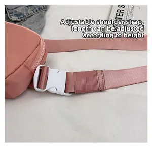 Close-up of pink oxford fabric adjustable strap with durable white plastic buckle