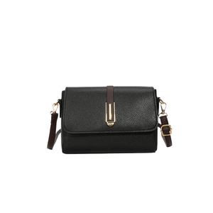 Elegant black lychee texture crossbody bag with gold hardware and contrast strap