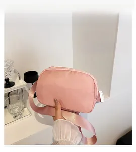 Detailed view of pink oxford fabric waist bag with adjustable strap and plastic buckle