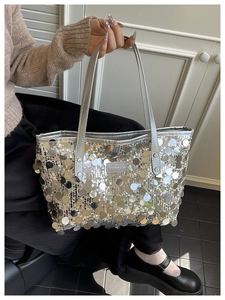 Detailed macro view of large silver sequin tote bag with a Creative Cat logo patch