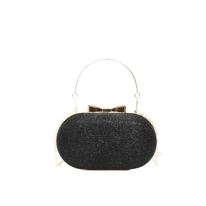 Elegant black glitter evening clutch bag with gold bow clasp and metal ring handle