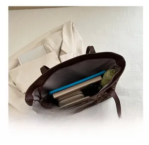 Spacious interior of leopard print tote bag holding tablet, notebook and daily essentials