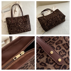 Detail of leopard print tote bag showing gold zipper, rivets, and leather handle grip