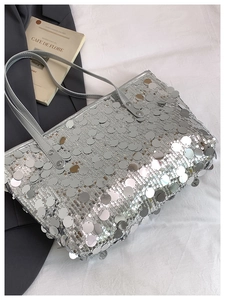 Detail of silver sequin tote bag with large round sequins and synthetic leather strap