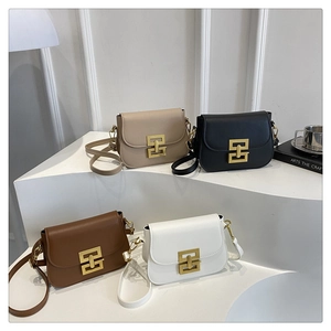 Four elegant minimalist crossbody bags with golden geometric locks on modern display