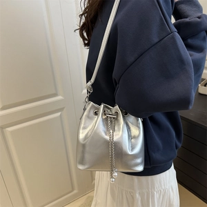 Silver metallic bucket bag with chain drawstring and pearl accents for women