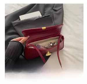Detail view of the open red crocodile pattern baguette bag showing its daily storage capacity
