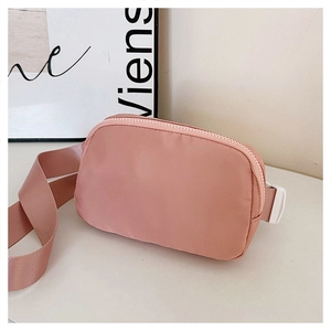 Detailed shot of mauve nylon mini belt bag featuring a matching strap and sturdy plastic buckle