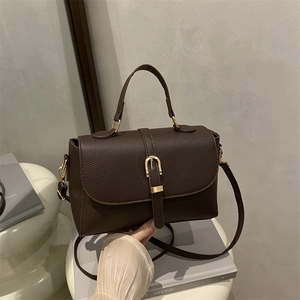 Deep brown lychee pattern leather handbag with gold buckle and adjustable crossbody strap