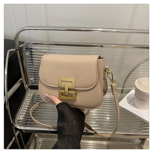 Close-up of beige square crossbody bag featuring premium gold interlocking metal clasp detail