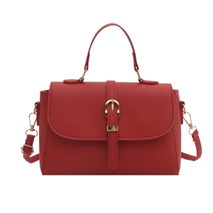 Red lychee pattern leather tote bag with gold buckle and adjustable crossbody strap