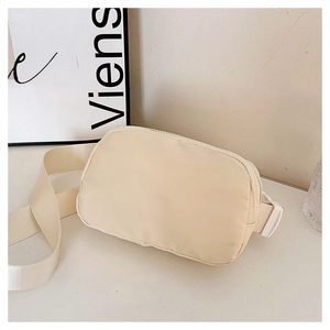 Detail of adjustable strap with durable buckle on cream nylon crossbody waist bag