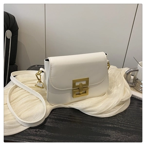Macro shot of minimalist white crossbody bag with geometric golden metal buckle