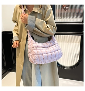 Close-up of pink quilted tote bag with silky satin finish and adjustable shoulder strap