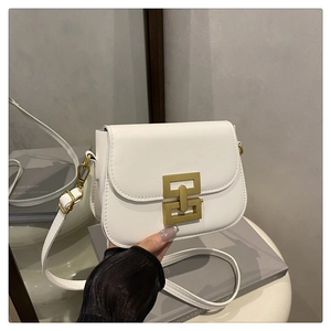 Detail of white leather shoulder bag featuring a geometric gold metal buckle lock
