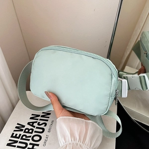 Mint green nylon crossbody belt bag with adjustable strap and buckle for women