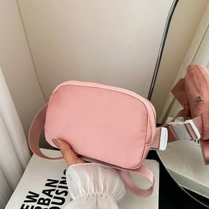 Pink nylon crossbody waist bag with adjustable strap and white buckle closure