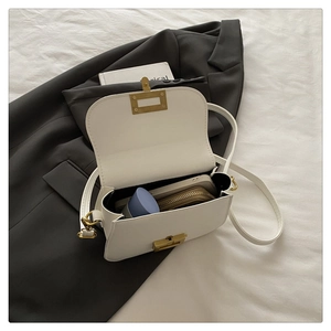 Interior view of white leather crossbody bag showing storage capacity and zipper pocket