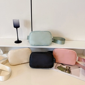 Nylon crossbody waist bags in mint, beige, black, and pink with adjustable straps