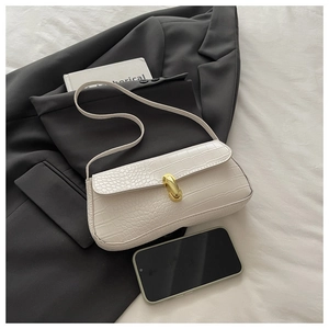 Detailed view of white crocodile pattern baguette bag with a premium gold metal buckle
