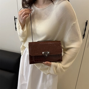Dark brown faux crocodile skin square bag with metallic chain strap and pyramid lock