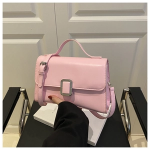 Detail of light pink vintage square bag with silver metallic buckle and leather texture