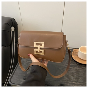 Detail showing the brown matte PU leather crossbody bag with a gold rectangular metal clasp