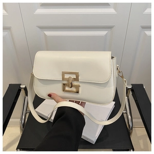 Close-up of white leather shoulder bag with golden rectangular metal clasp and flap