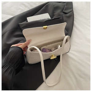 Interior view of white crocodile pattern baguette bag showing space for phone and lipstick