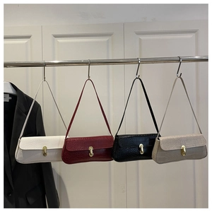 Detail showing various colors of crocodile pattern baguette bags with gold buckle accents