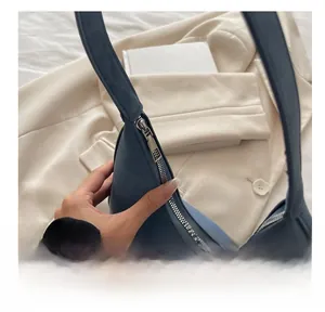 Detailed close-up of the smooth silver metal zipper on this blue vintage tote bag