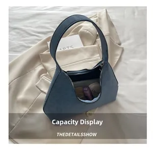 Internal view of blue leopard print shoulder bag showing makeup storage capacity