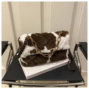 Détail du sac matelassé en fausse fourrure motif vache avec chaîne et bandoulière
